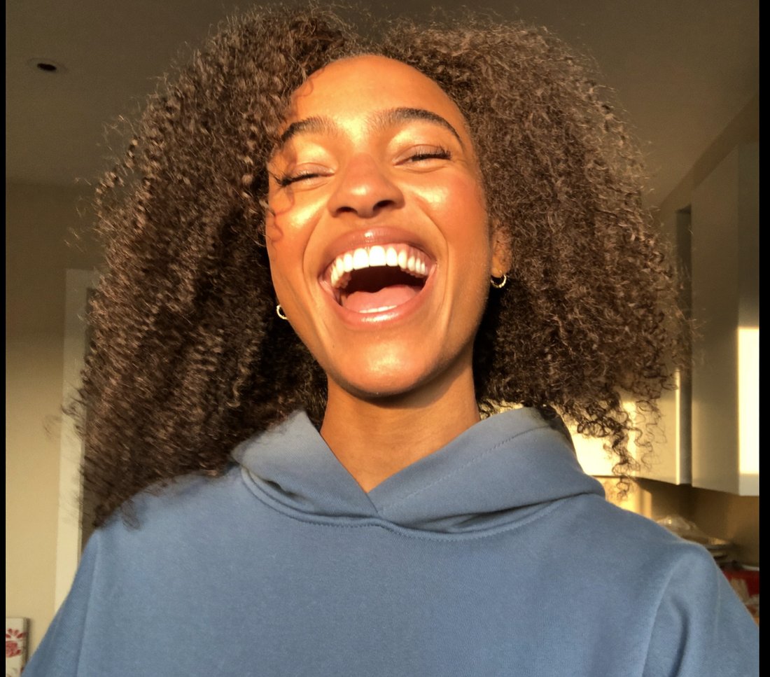 Laughing woman in her kitchen
