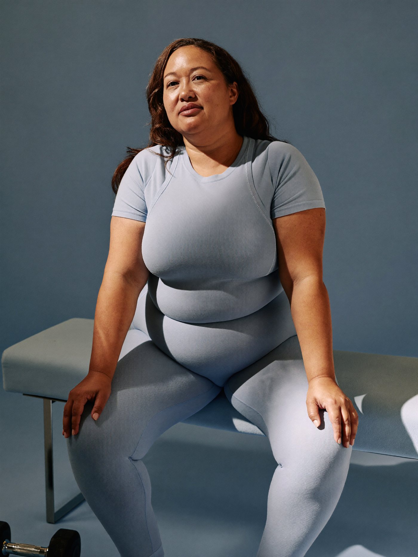 Strong woman resting between sets, calm and unhurried